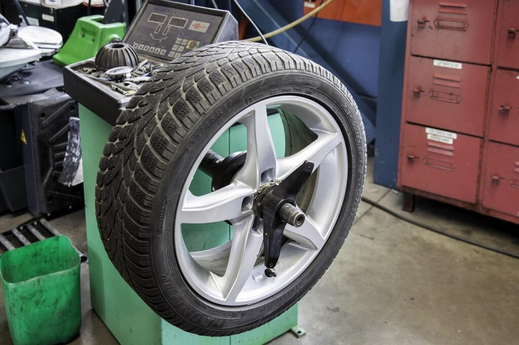 Car wheel mounted on tyre replacement and balancing equipment