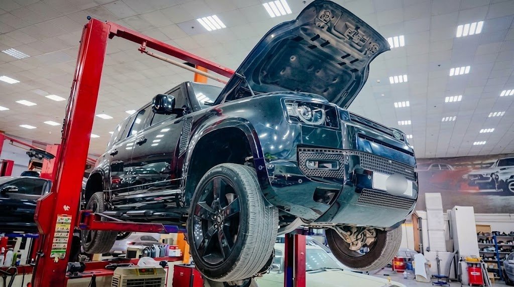 SUV raised on a workshop lift for inspection.
