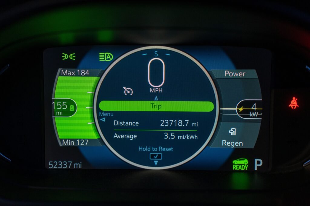 electric-vehicle-service-in-dubai.Detailed view of an electric vehicle's dashboard showing speed, battery range, and power metrics.